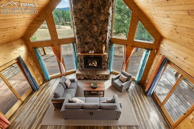 a living room with furniture a large window with wooden floor