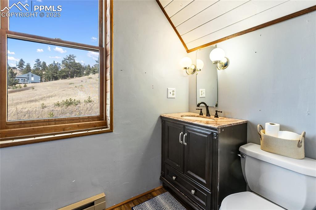 795 South Mountain Estates Road Florissant, CO 80816 - Photo 28 of 42 a bathroom with a toilet sink and mirror