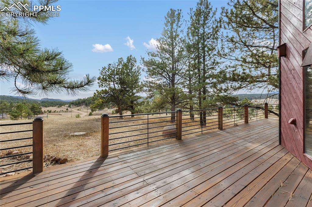 795 South Mountain Estates Road Florissant, CO 80816 - Photo 4 of 42 a view of a terrace with wooden floor and fence