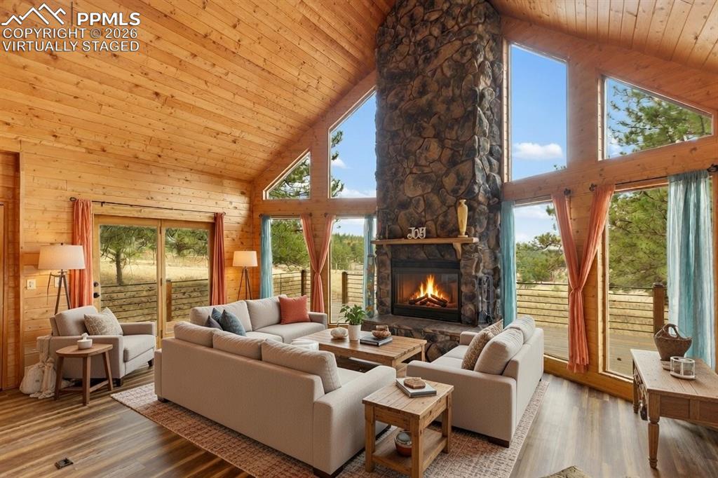 795 South Mountain Estates Road Florissant, CO 80816 - Photo 6 of 42 a living room with furniture and a large window