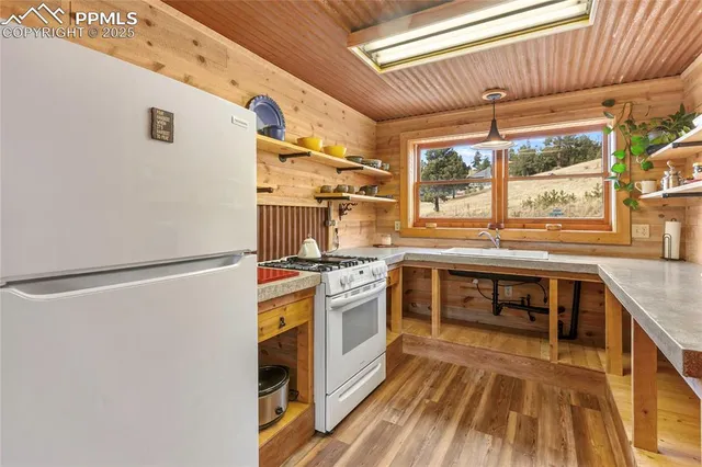 a kitchen with stainless steel appliances granite countertop a refrigerator and a stove