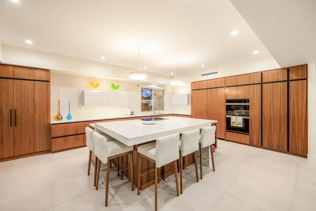 a dining room with a wooden table and chairs