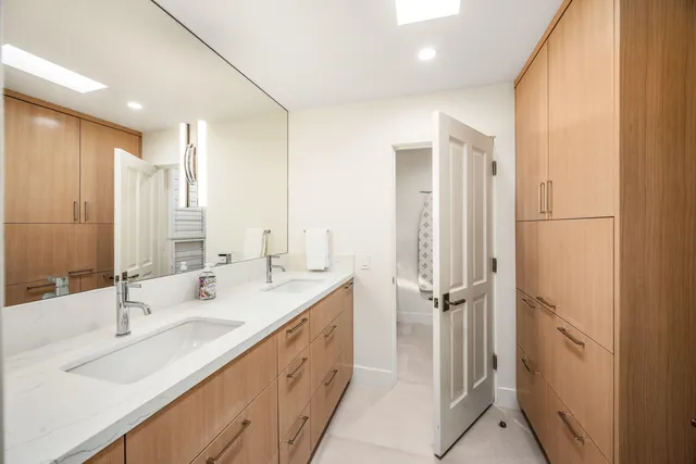 a bathroom with a double vanity sink mirror and double