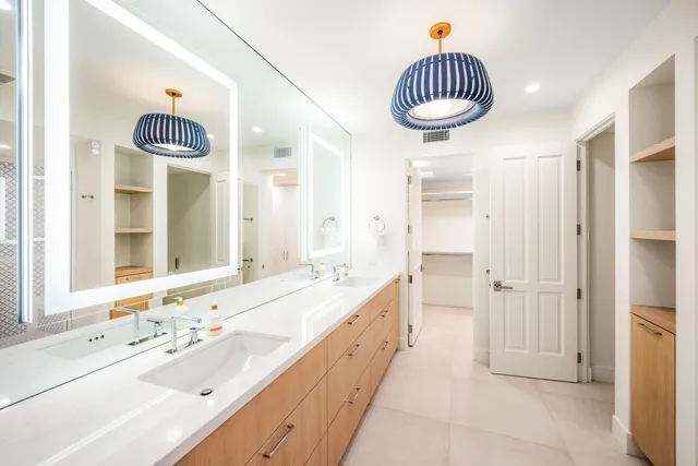 a bathroom with a sink a mirror a bathtub and a shower