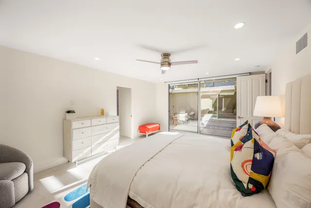 a bed room with a bed a couch and a window