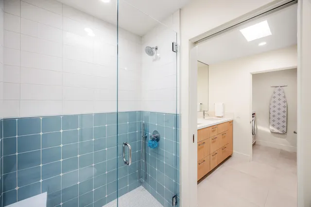 a bathroom with a granite countertop sink a toilet and shower