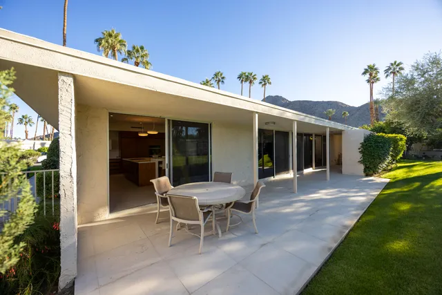 a view of a house with backyard sitting area and porch