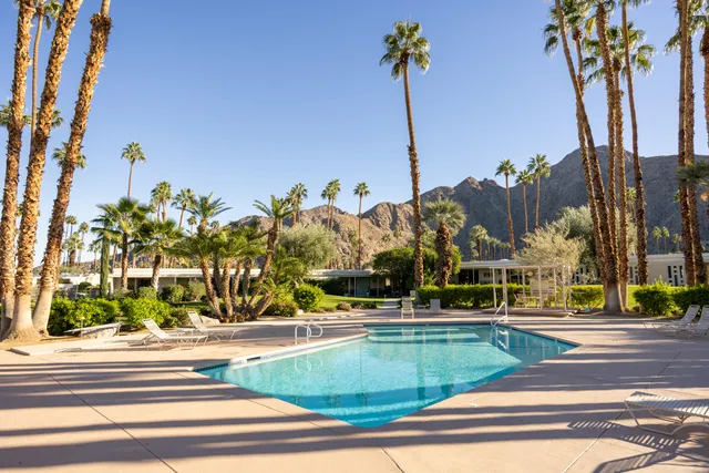a view of a water fountain and a tall building in the background