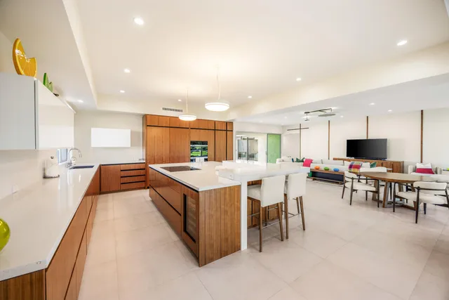 a kitchen with kitchen island a sink table and chairs