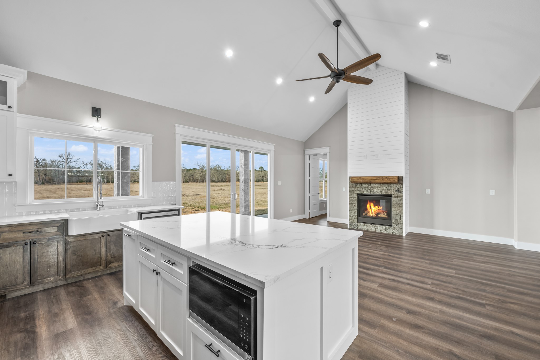 93 Longhorn Loop New Waverly, TX 77358 - Photo 12 of 47 a large kitchen with granite countertop a stove and a sink