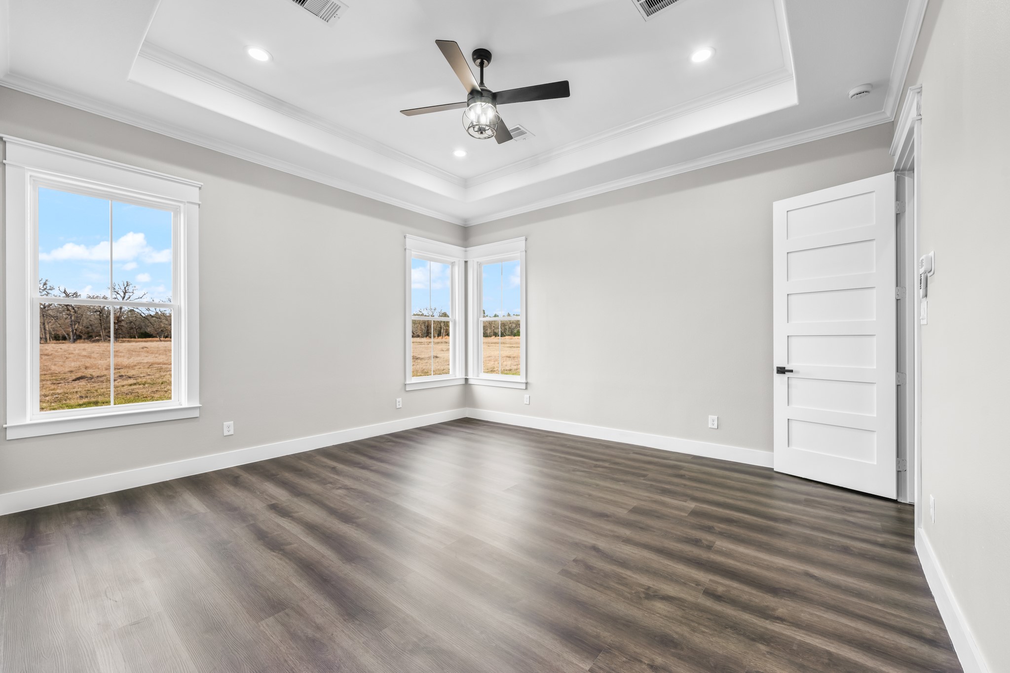 93 Longhorn Loop New Waverly, TX 77358 - Photo 19 of 47 wooden floor in an empty room with a window