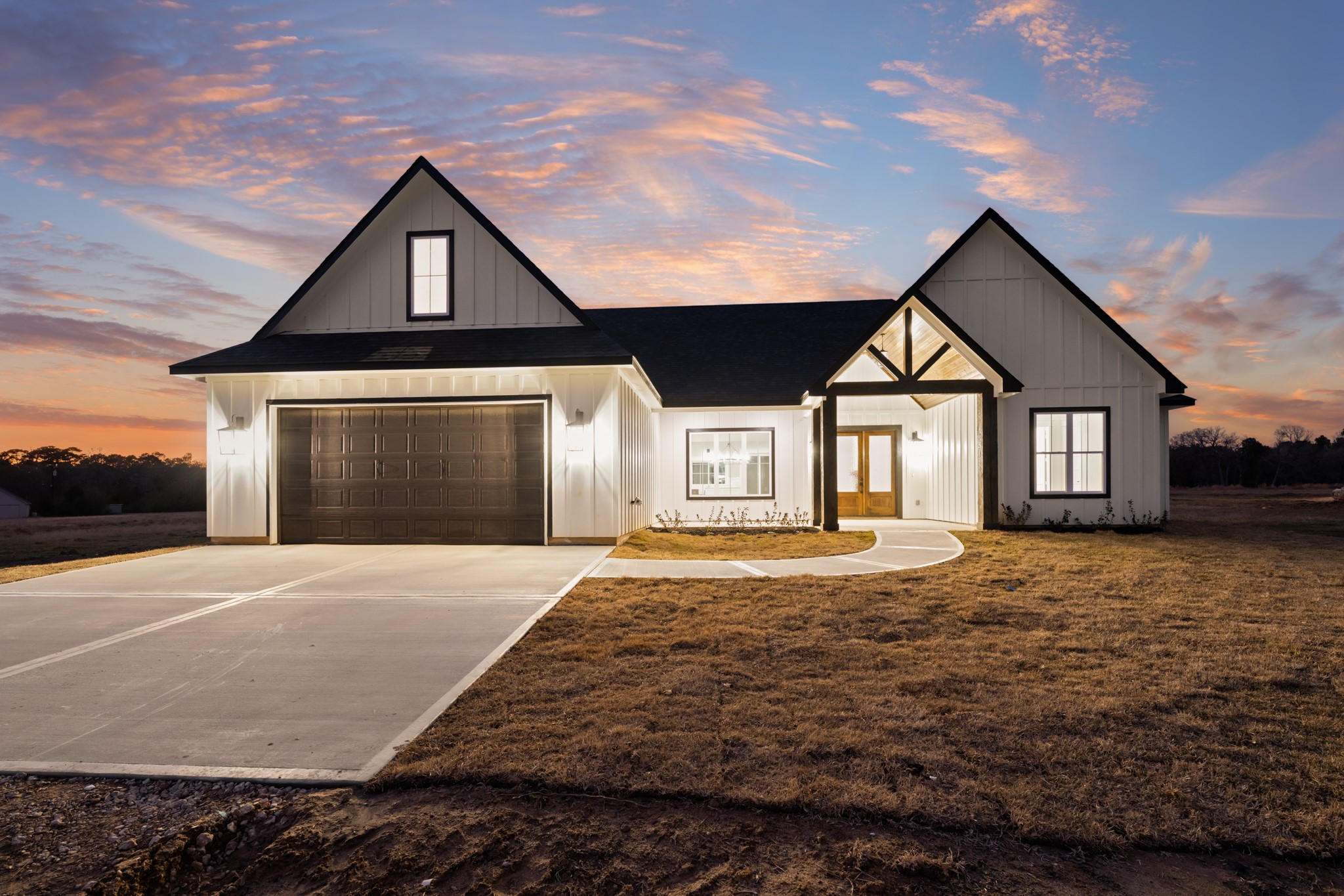 93 Longhorn Loop New Waverly, TX 77358 - Photo 2 of 47 a front view of a house with a yard and garage