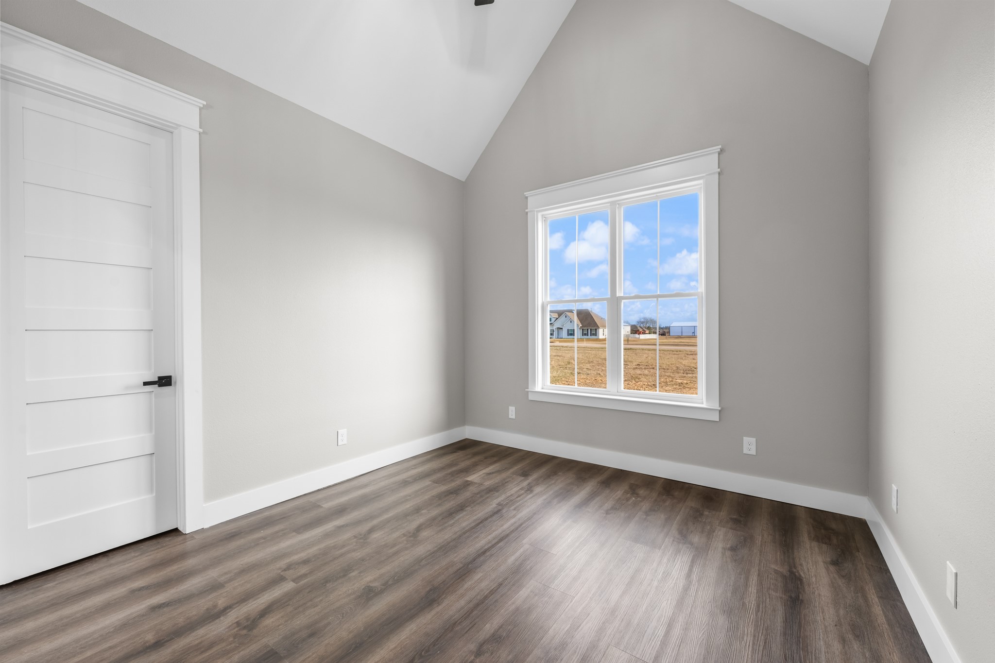 93 Longhorn Loop New Waverly, TX 77358 - Photo 23 of 47 a view of an empty room with wooden floor and a window