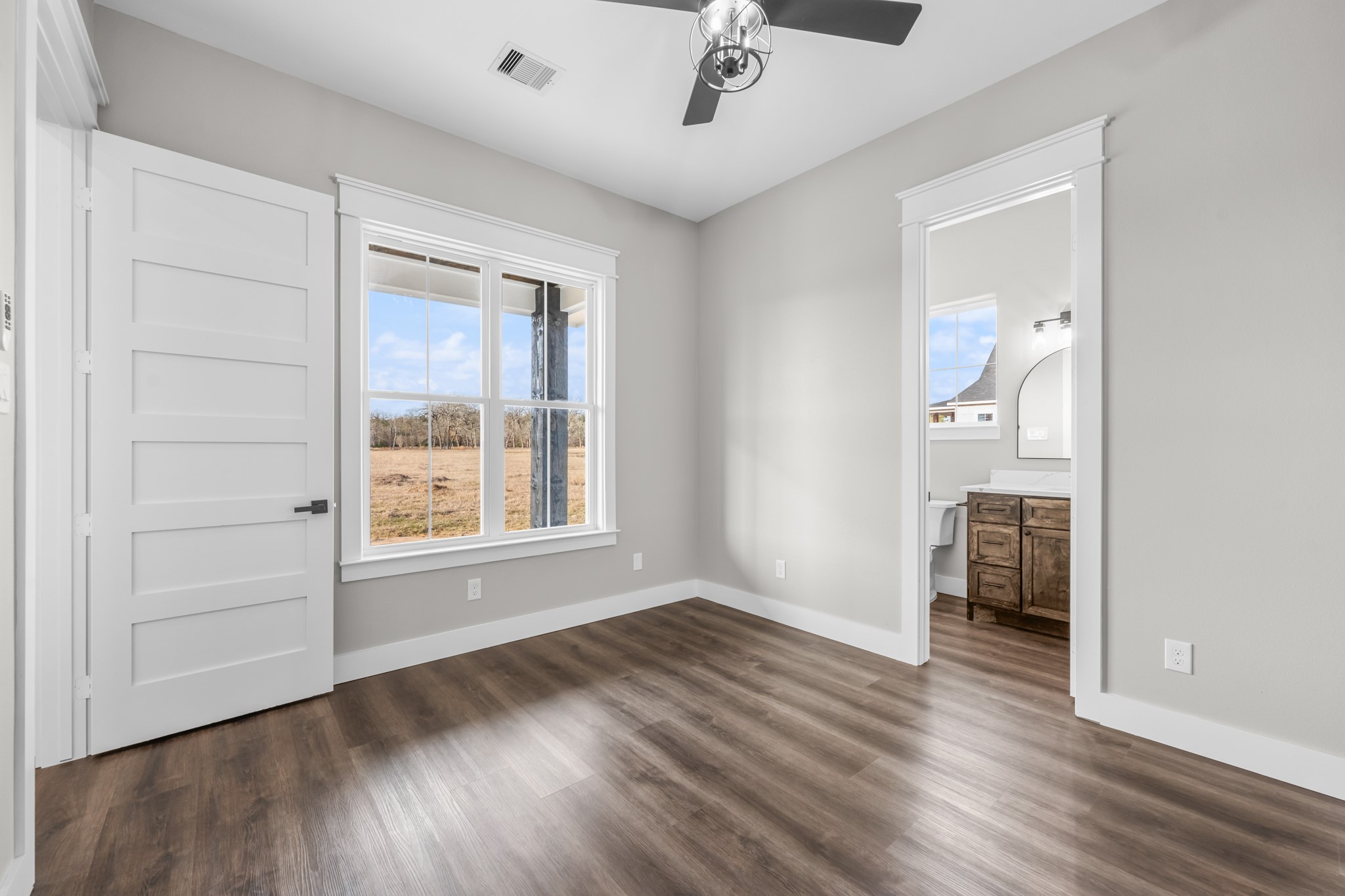 93 Longhorn Loop New Waverly, TX 77358 - Photo 26 of 47 an empty room with wooden floor and windows