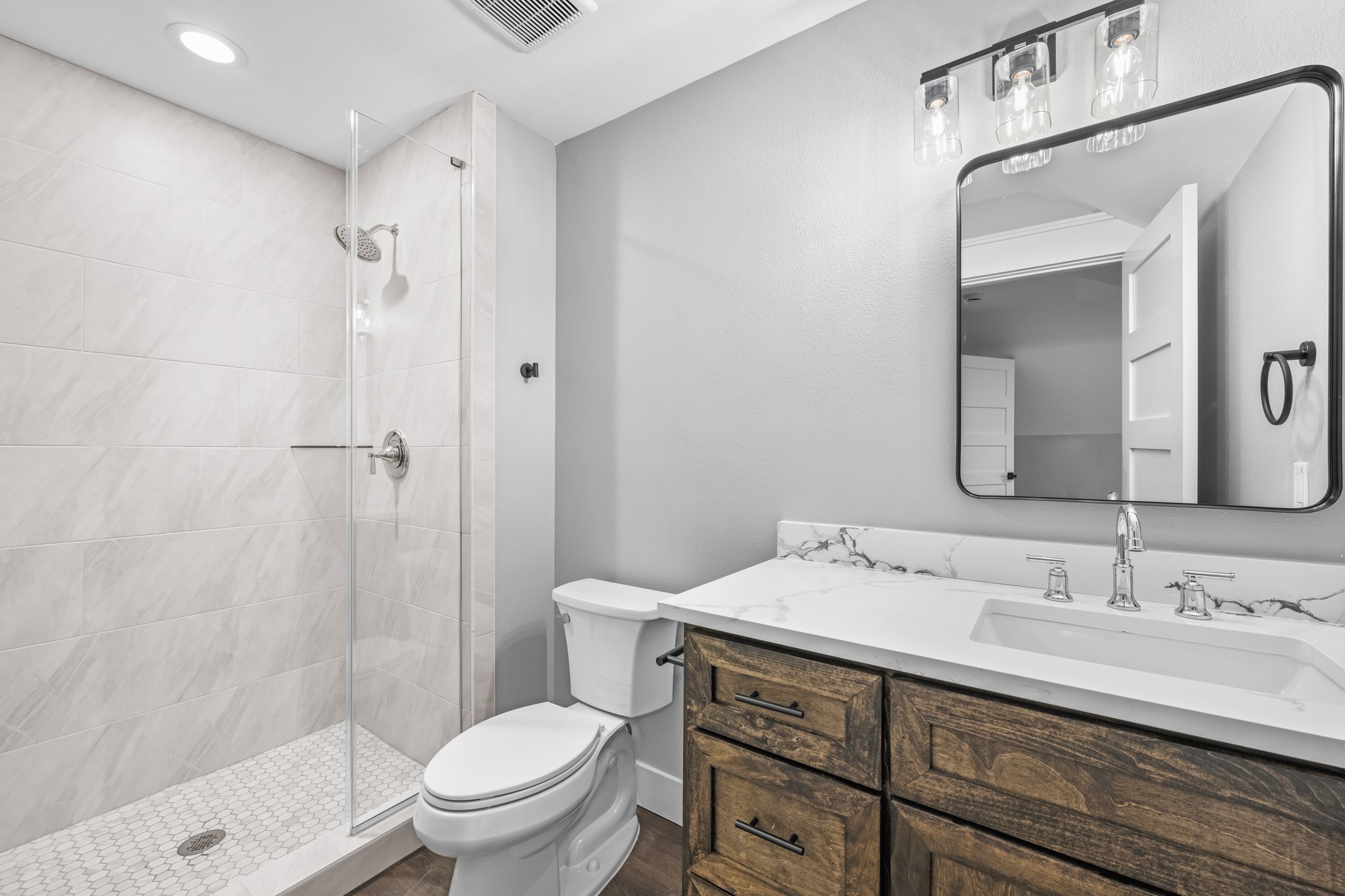 93 Longhorn Loop New Waverly, TX 77358 - Photo 30 of 47 a bathroom with a double vanity sink toilet and shower