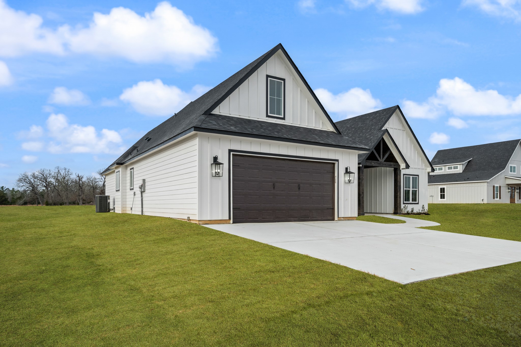 93 Longhorn Loop New Waverly, TX 77358 - Photo 46 of 47 a front view of a house with yard and garage