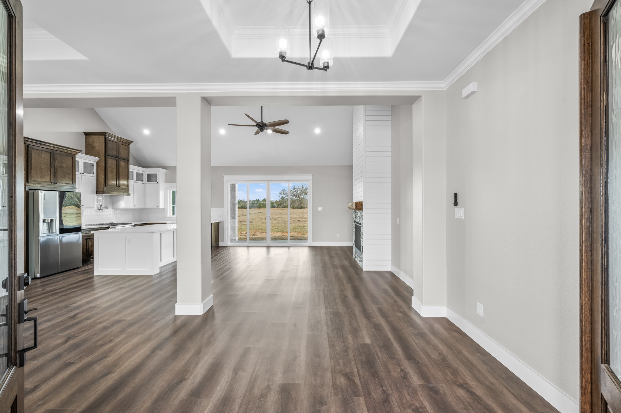 93 Longhorn Loop New Waverly, TX 77358 - Photo 5 of 47 a view of a hallway with wooden floor and a kitchen