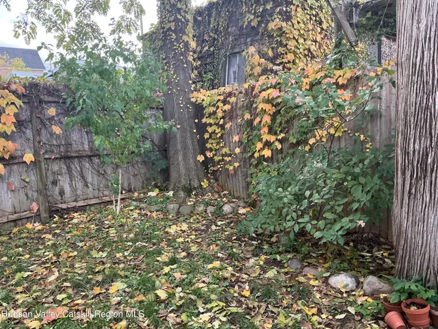 a backyard of a house with lots of green space and a fountain