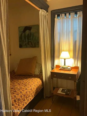 a bedroom with a bed and with furniture