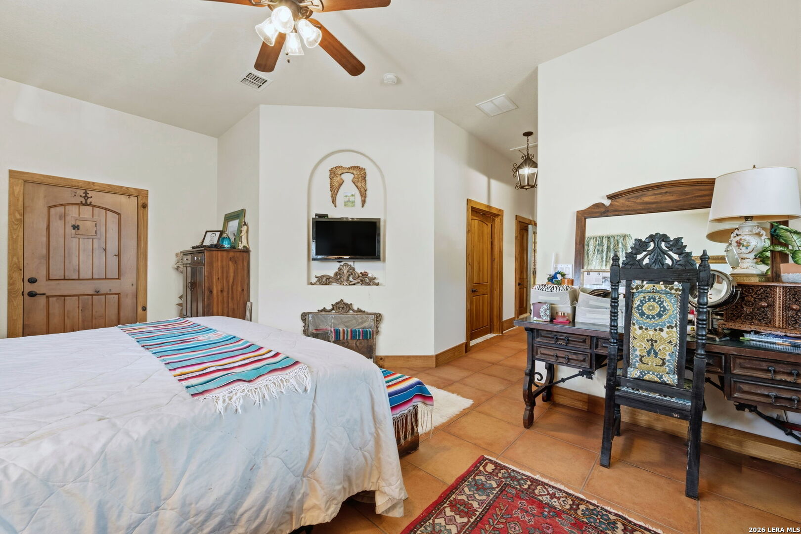 1150 Bruce Road Poteet, TX 78065 - Photo 22 of 33 a bedroom with a bed and a chandelier