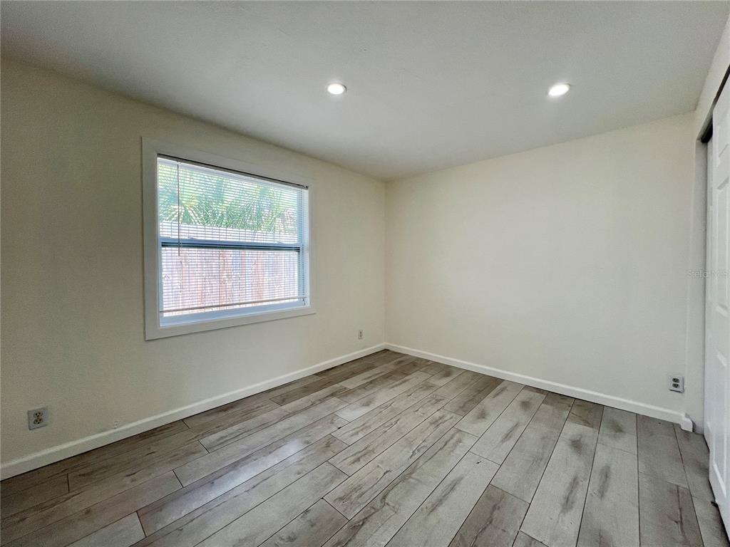 1716 West Nassau Street Tampa, FL 33607 - Photo 13 of 25 an empty room with wooden floor and windows