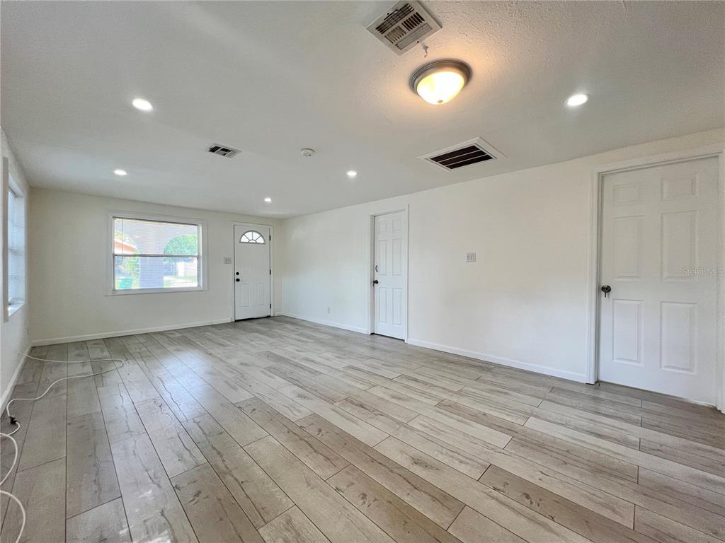 1716 West Nassau Street Tampa, FL 33607 - Photo 6 of 25 an empty room with wooden floor and windows