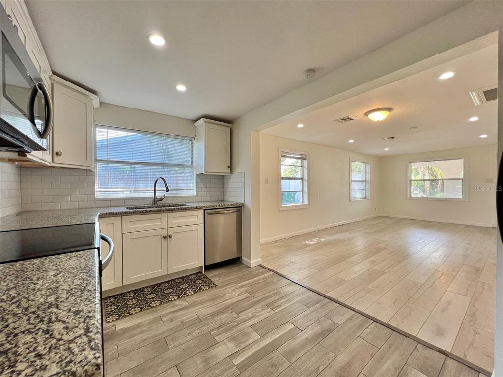 1716 West Nassau Street Tampa, FL 33607 - Photo 9 of 25 a view of a kitchen with a sink and dishwasher with wooden floor
