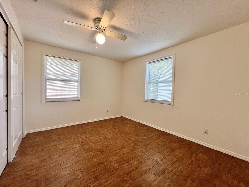 1716 West Nassau Street Tampa, FL 33607 - Photo 10 of 25 an empty room with wooden floor ceiling fan and windows