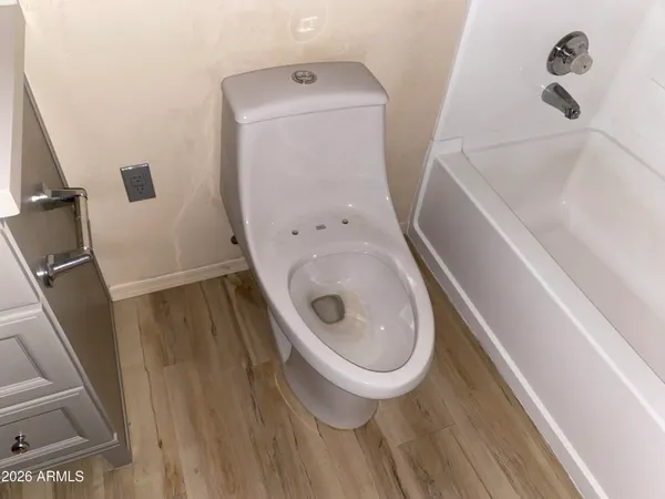 a room with wooden floor and gym equipment