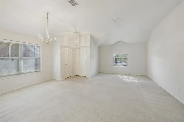 an empty room with a empty space and windows