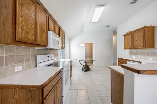 a kitchen with a sink appliances and cabinets