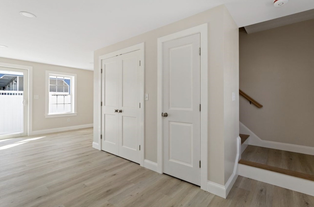 209 Main Street, Unit 6 Dennis, MA 02670 - Photo 18 of 27 a view of an empty room with wooden floor and a window