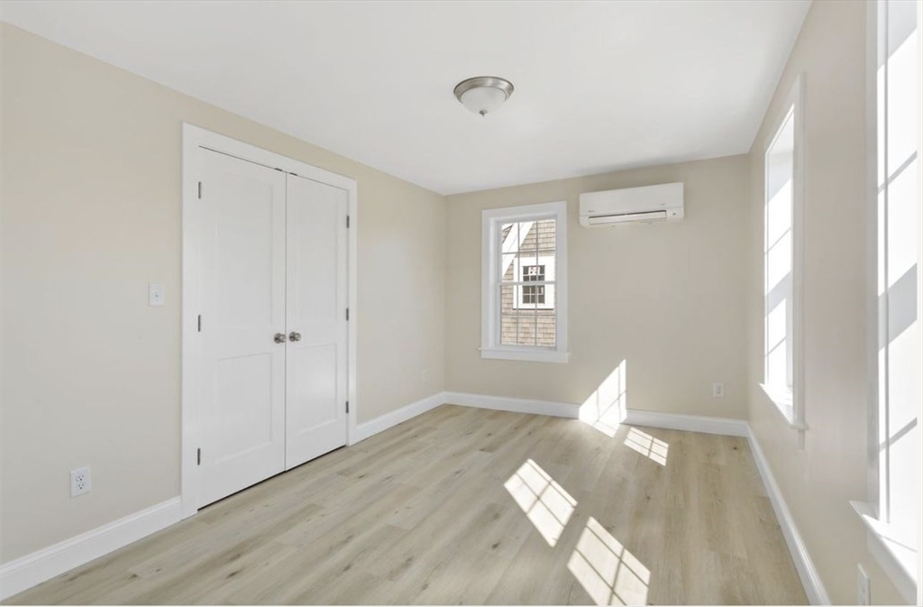 209 Main Street, Unit 6 Dennis, MA 02670 - Photo 22 of 27 a view of empty room with wooden floor and fan