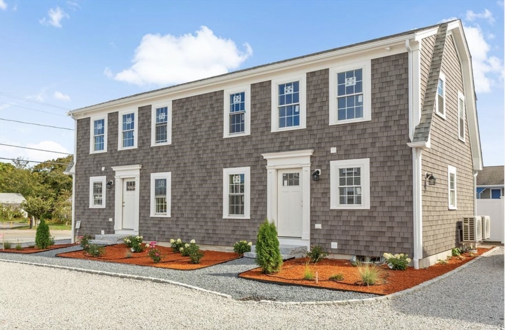 209 Main Street, Unit 6 Dennis, MA 02670 - Photo 5 of 27 a front view of a house with yard and seating space