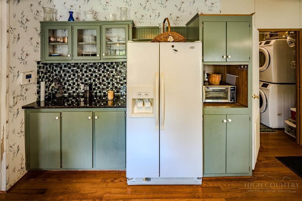 461 Reuben Wooten Road Banner Elk, NC 28604 - Photo 14 of 39 a view of a kitchen with wooden floor and a refrigerator
