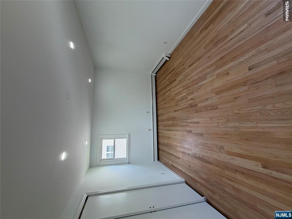 53 Devon Terrace, Unit 2 Kearny, NJ 07032 - Photo 10 of 15 an empty room with wooden floor and windows