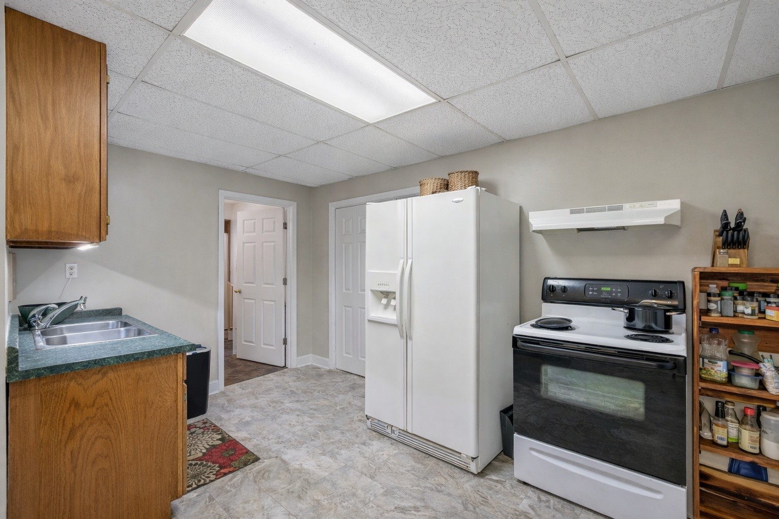 311 Downs Road Cumberland City, TN 37050 - Photo 23 of 31 a kitchen with a stove and a refrigerator