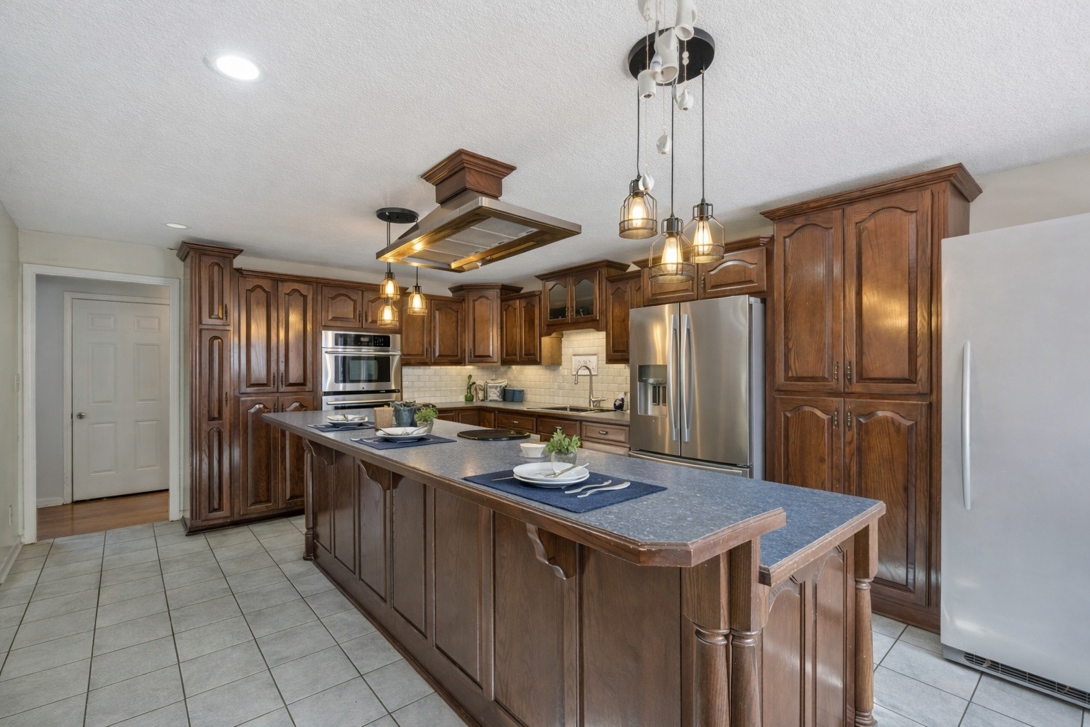 311 Downs Road Cumberland City, TN 37050 - Photo 10 of 31 a kitchen that has a lot of cabinets a sink and a stainless steel appliances