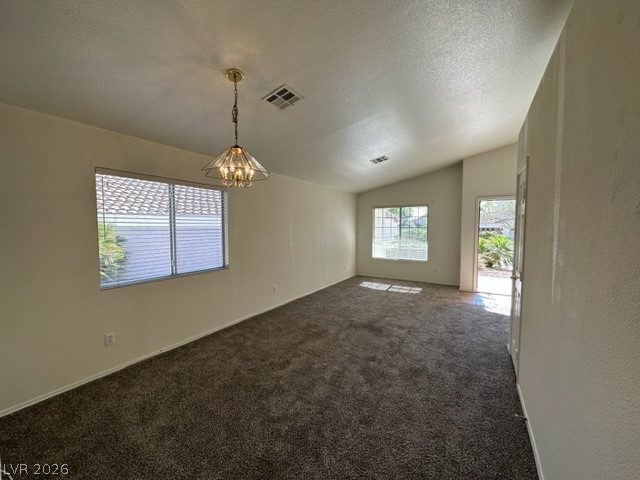 285 Spring Palms Street Henderson, NV 89012 - Photo 4 of 38 Living room featuring a notable chandelier, visible vents, dark carpet, and vaulted ceiling