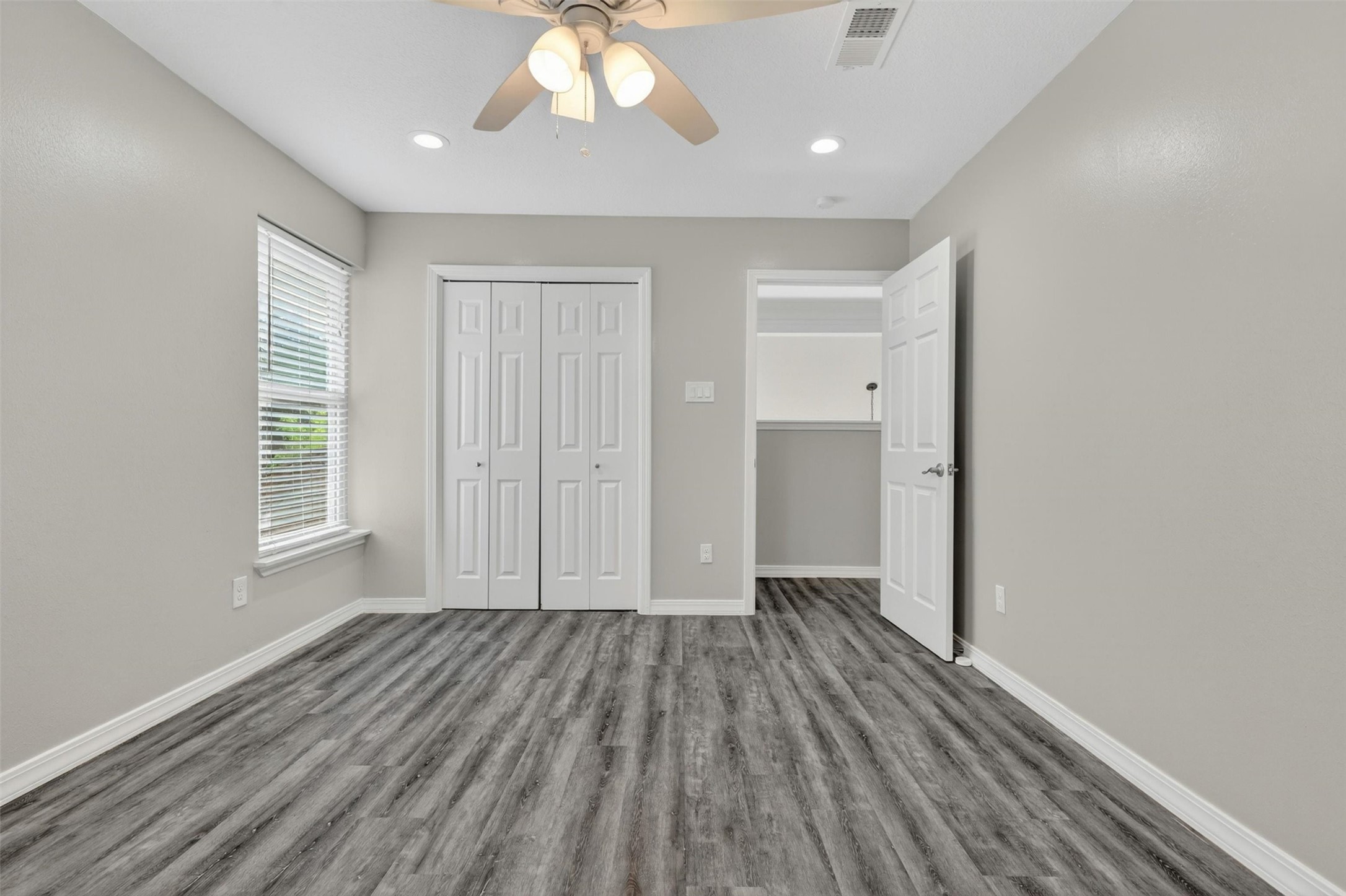 12929 Kingsbridge Lane Houston, TX 77077 - Photo 35 of 42 Spacious and inviting bedroom featuring modern flooring, recessed lighting, and a bright neutral color palette that creates a clean contemporary feel buyers love. This versatile room offers generous closet space, abundant natural light, and a functional layout perfect for family, guests, a home office, or flex space. Buyers will appreciate the move-in ready condition, updated finishes, and comfortable open atmosphere designed for today’s lifestyle.
