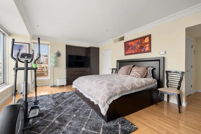 a bedroom with a bed and a television in it