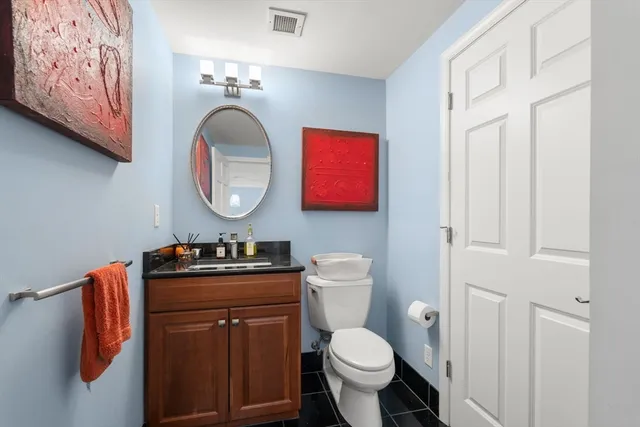 a bathroom with a toilet a sink and a mirror