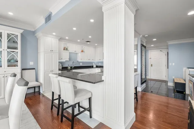 a view of a kitchen and dining area with chandelier in it
