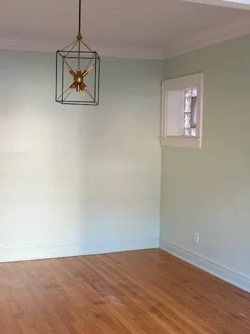 a view of a room with wooden floor and ceiling fan