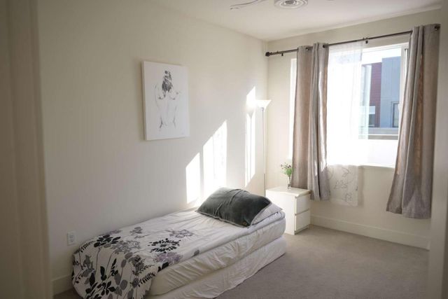 a living room with furniture a large window and a table