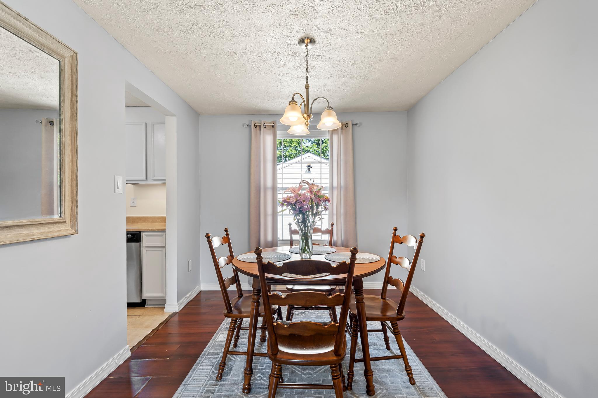 1839 Lawnview Drive Frederick, MD 21702 - Photo 14 of 42 a dining room with furniture a chandelier and wooden floor