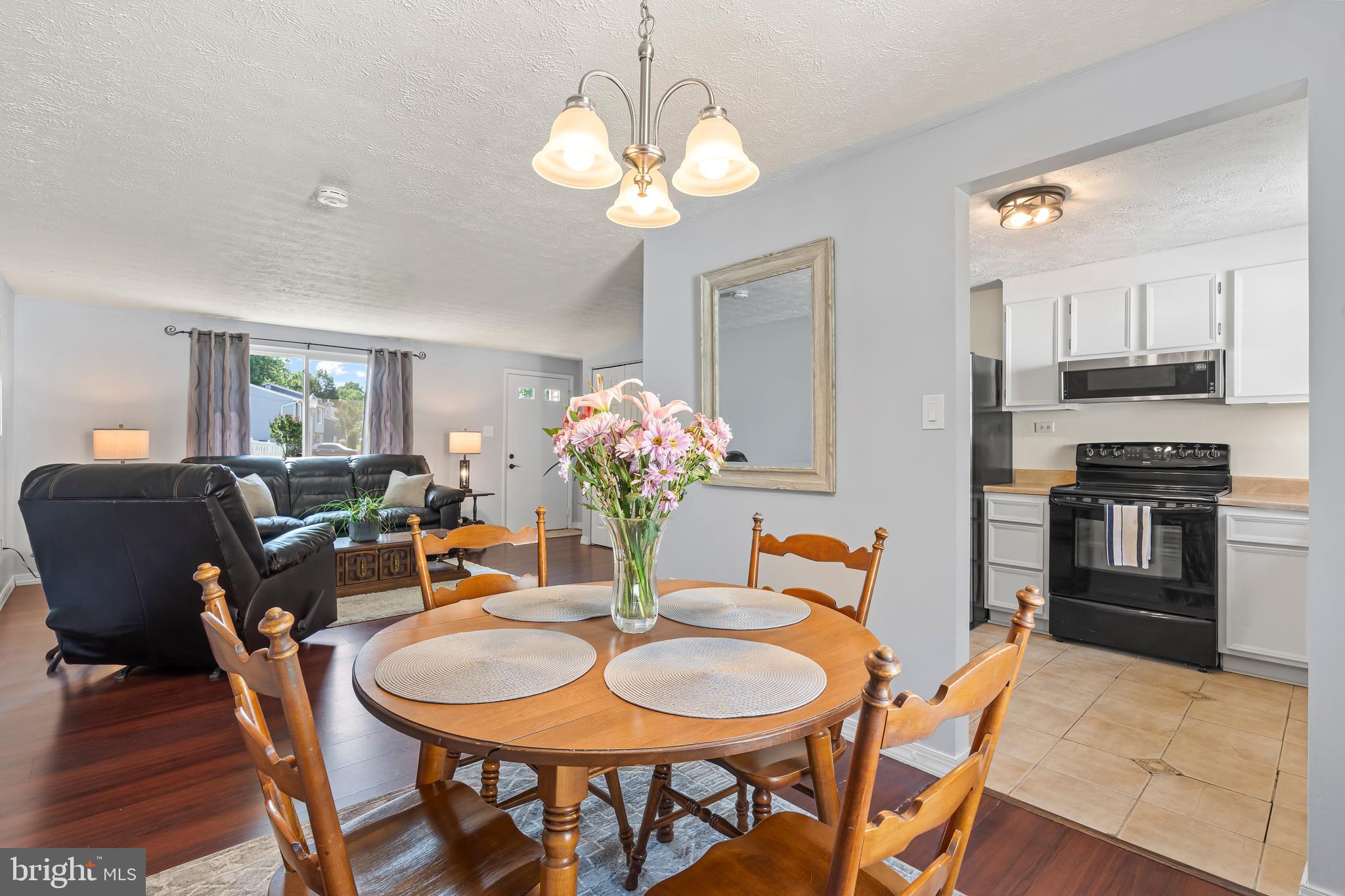 1839 Lawnview Drive Frederick, MD 21702 - Photo 15 of 42 a dining room filled chandelier and wooden floor