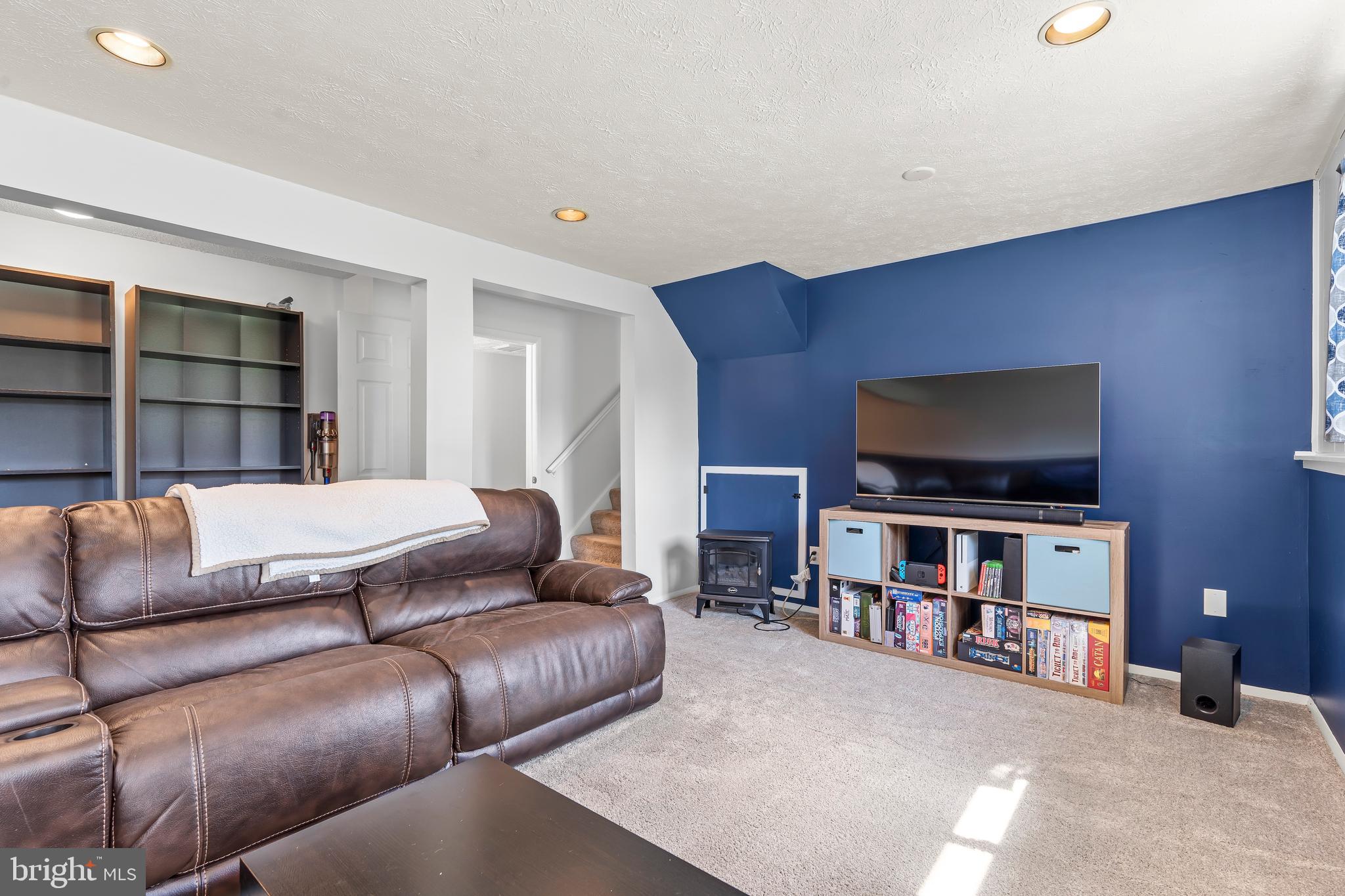 1839 Lawnview Drive Frederick, MD 21702 - Photo 32 of 42 a living room with furniture and a flat screen tv