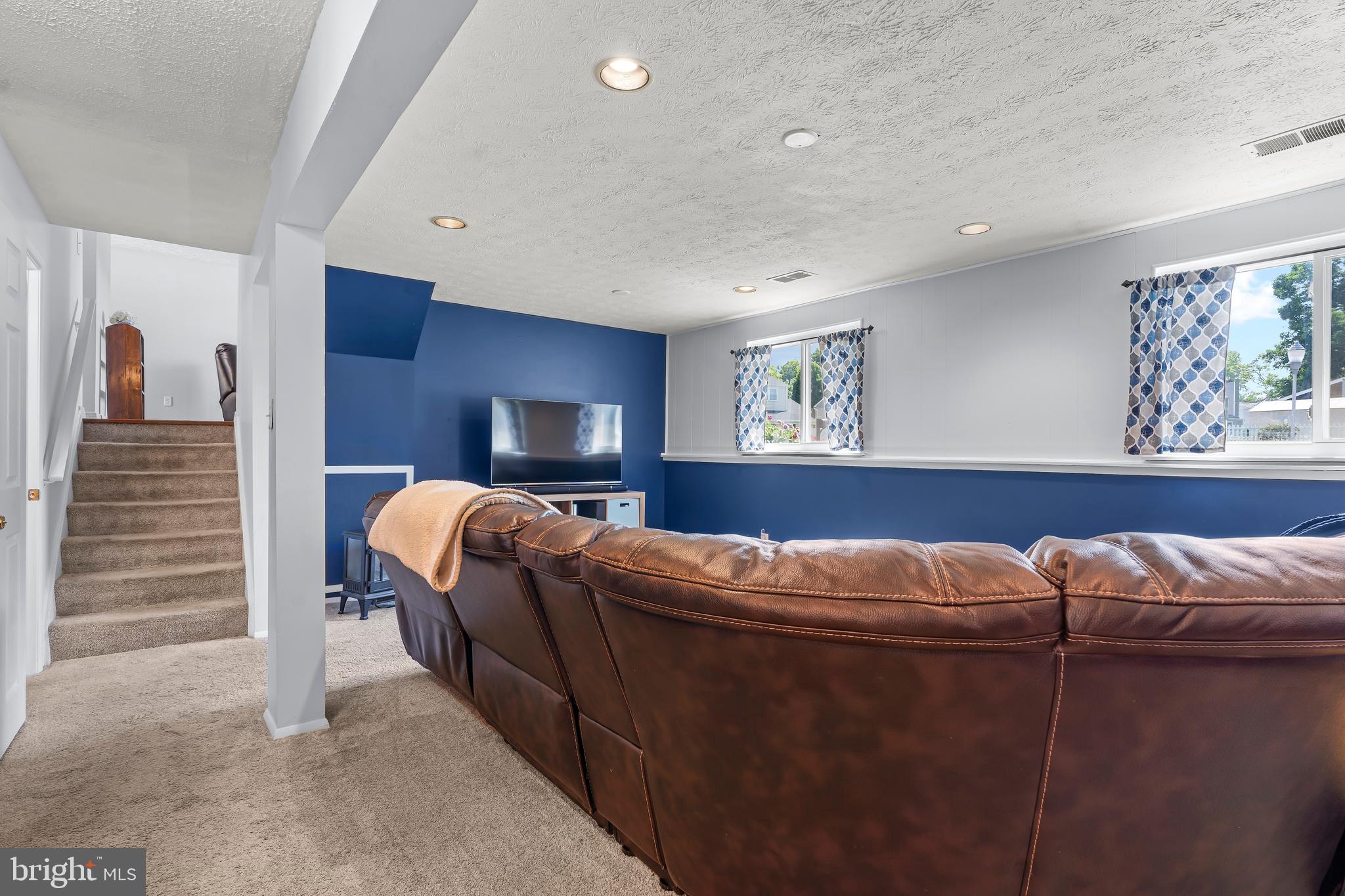 1839 Lawnview Drive Frederick, MD 21702 - Photo 33 of 42 a living room with furniture a ceiling fan and a window