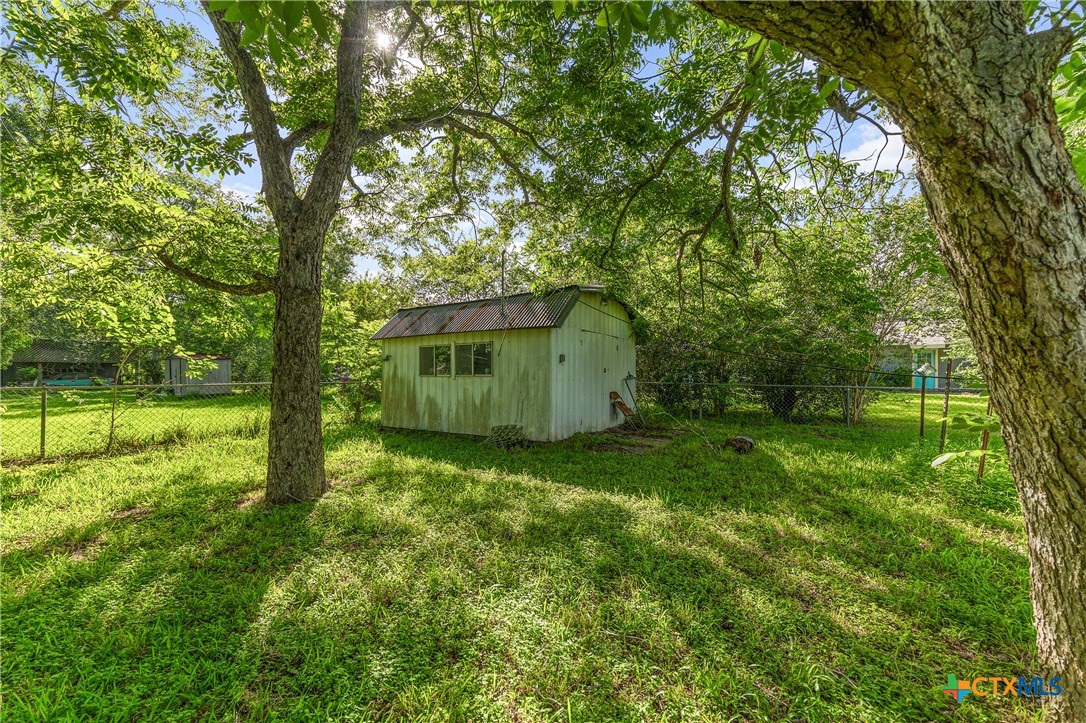 401 Kerr Street Edna, TX 77957 - Photo 17 of 23 a backyard of a house with lots of green space